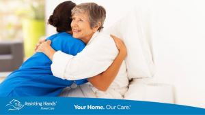 Happy elderly woman smiling with caregiver Assisting Hands Caregiving