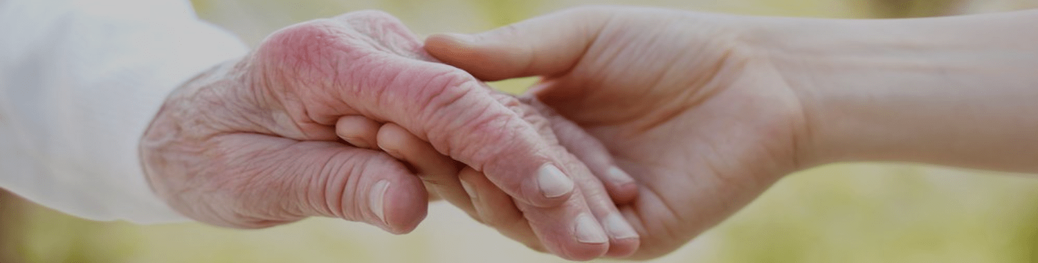 Caregivers hand holding a senior's Assisting-Hands-Midwest-Caregivers-Services
