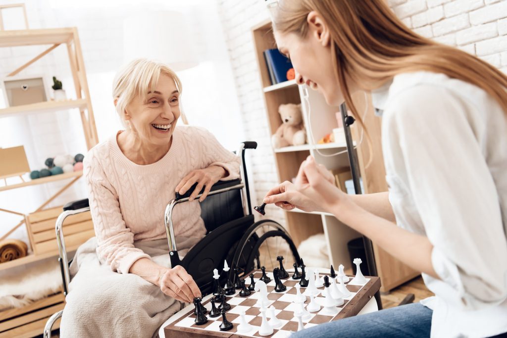 Daughter Playing Chess with Elderly Mother